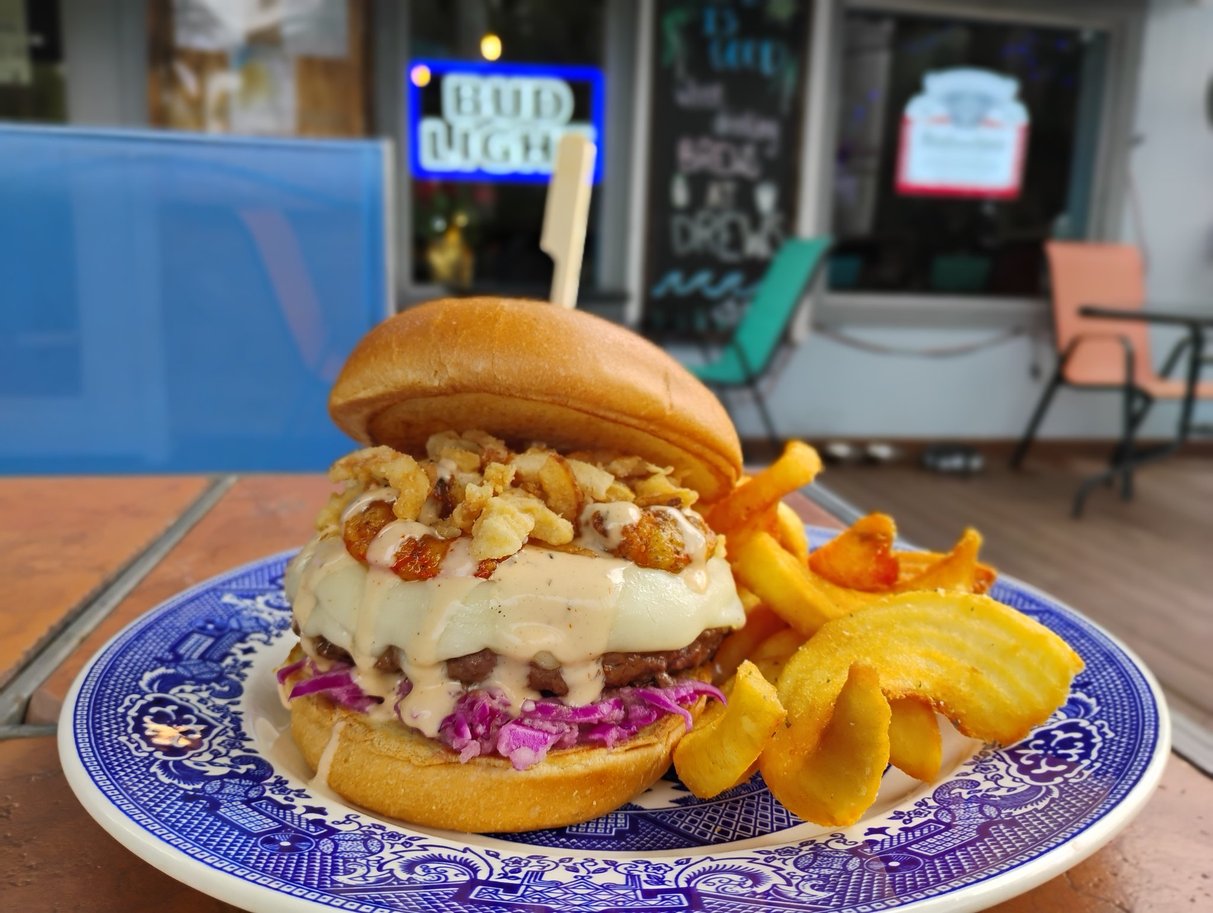 The Bang Bang Shrimp, December 2025 Burger of the Month, with provolone, Cajun fried blue shrimp, onion tanglers, and Reaper ranch