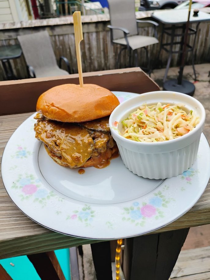 The Diane, August 2026 Burger of the Month, with slow roasted brisket, caramelized onions, and Diane sauce on a brioche bun