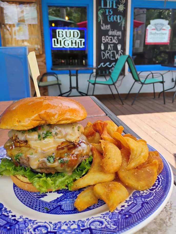 The Hawaiian, June 2026 Burger of the Month, with teriyaki chicken, pepper jack cheese, grilled pineapple, and cilantro
